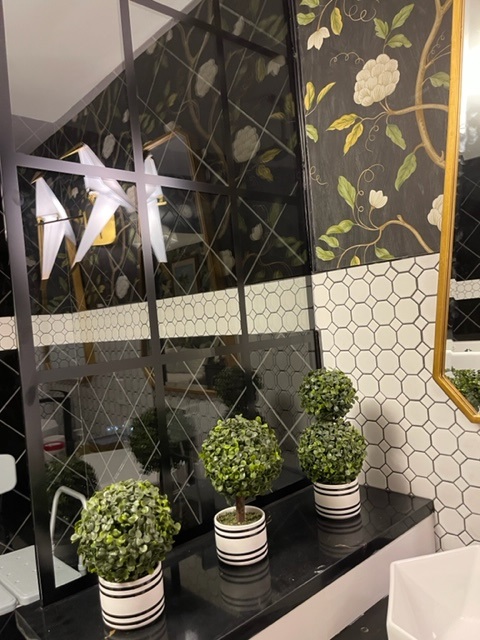 Beautiful Cambria Quartz, black with gold veining, and a stylish backsplash tile create an enchanting new bathroom